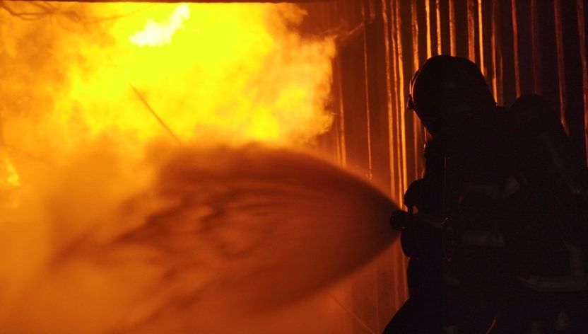 Firefighter spraying water