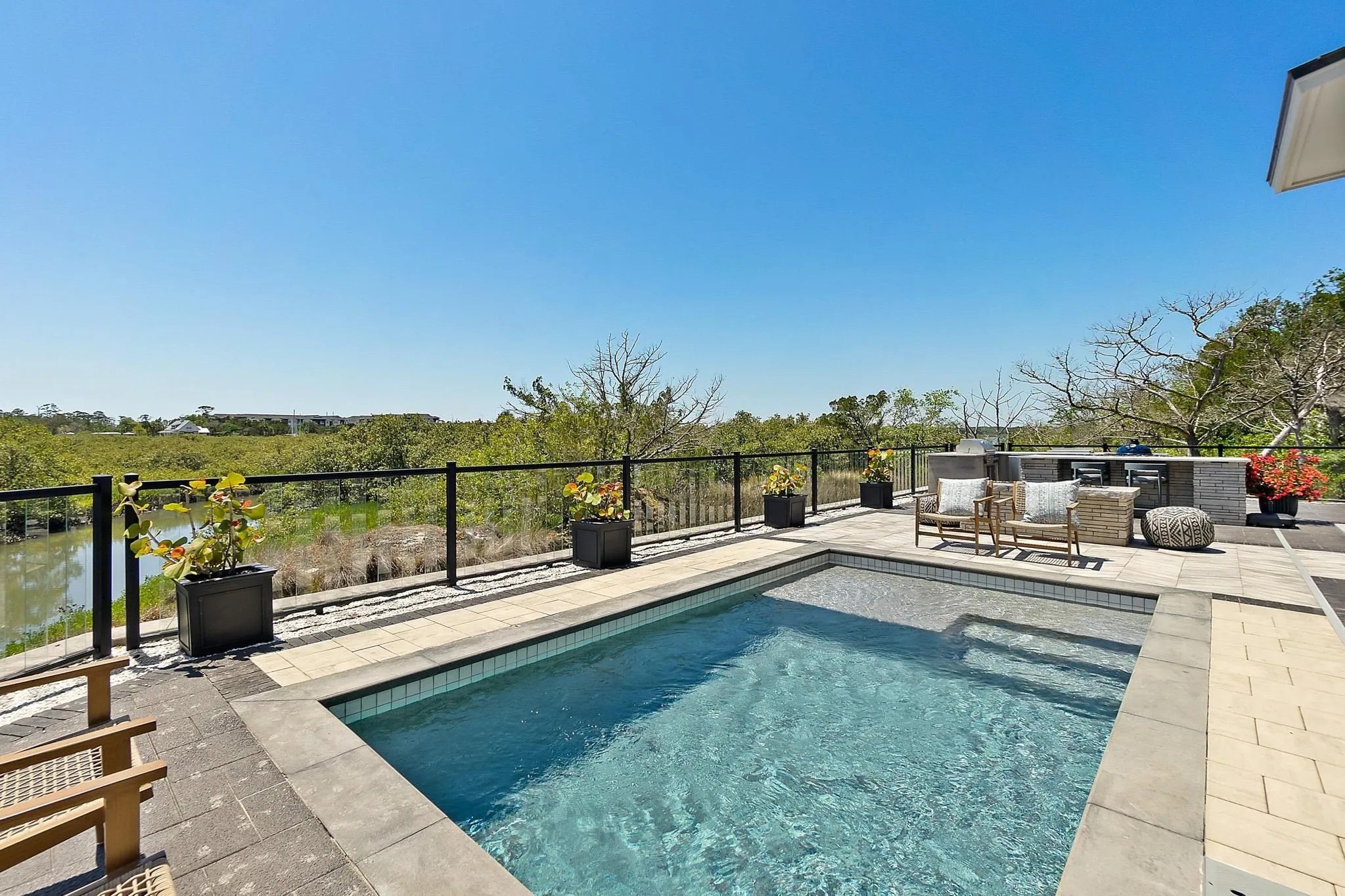 The backyard features a resort-like pool with a view.
