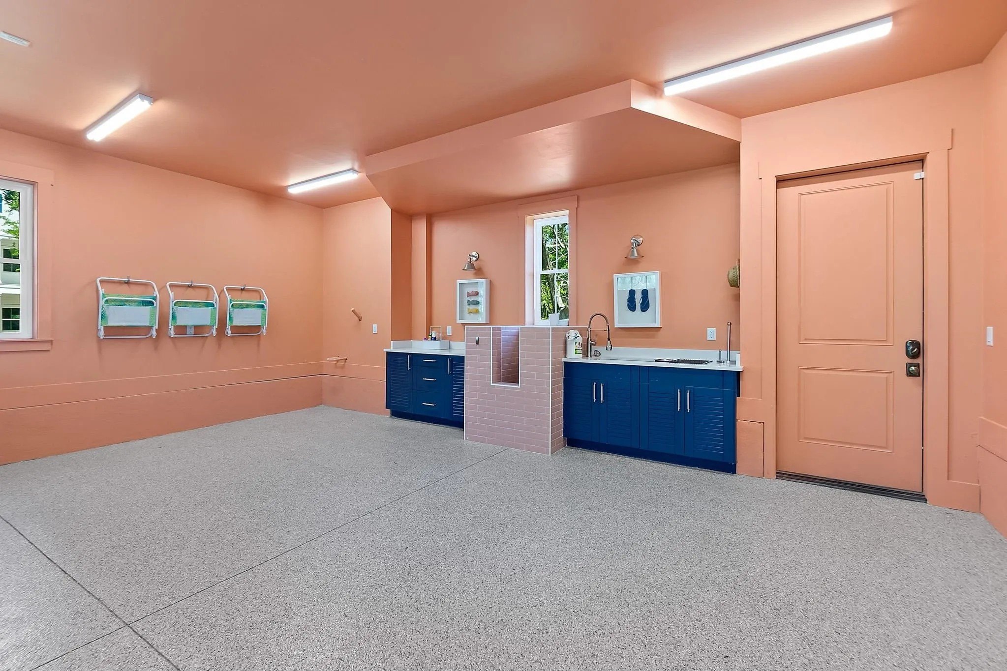 Even the garage is fancy, with it's pale orange walls, sink, work station and dog bath.