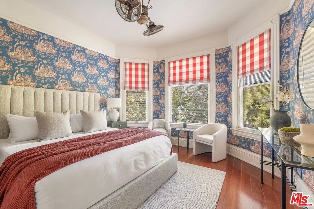 The primary suite enjoys a view from a large bay window.