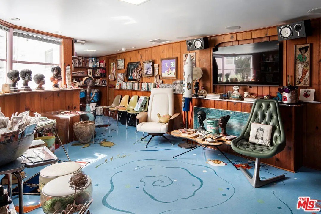 The walk-out basement is outfitted like an aquarium, with a blue linoleum floor. Singing fish included.