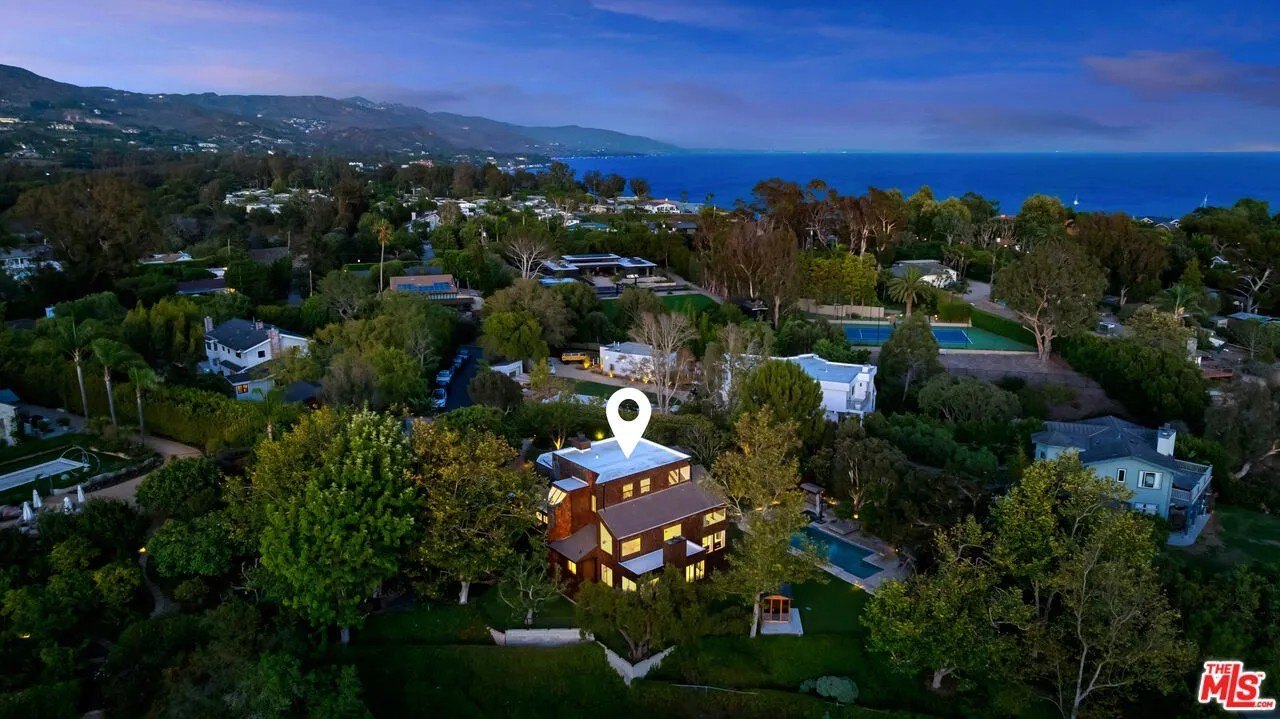 The expansive grounds are marked by mature landscaping, a pool and spa, multiple lounging terraces, a cedar sauna, a barbecue area and a flat lawn.
