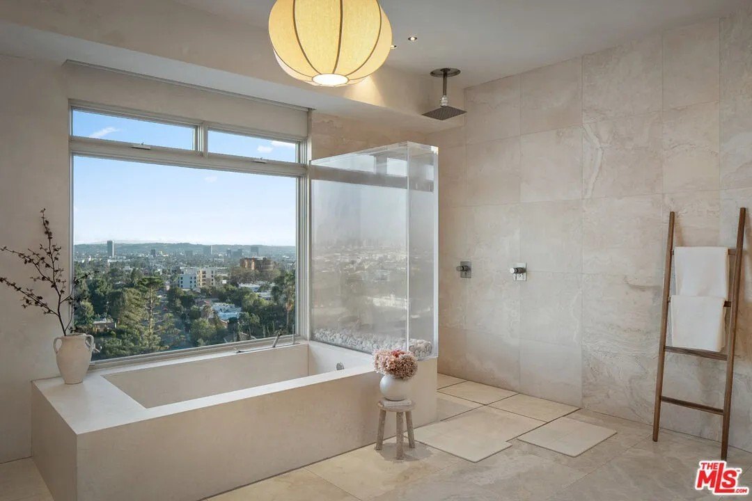 That glass wall between the shower and tub can double as a fish tank if you're so inclined.