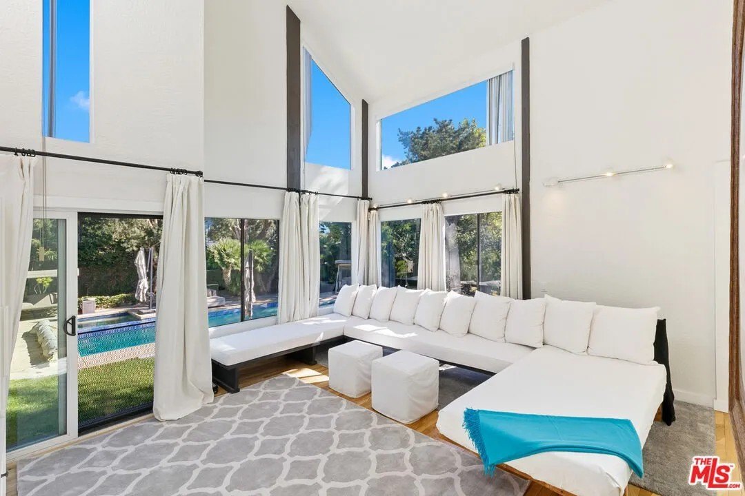 The two-story home is illuminated by multiple large clerestory, canyon-facing picture windows and skylights.