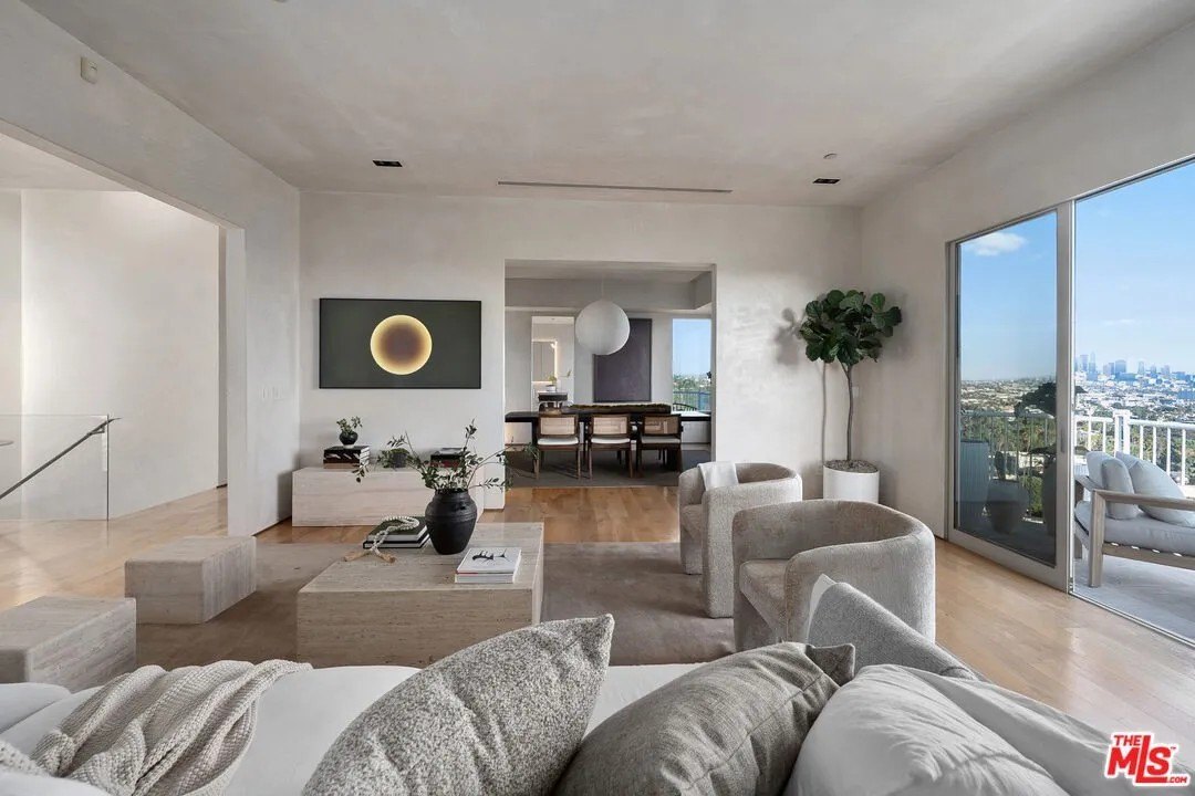 The main floor opens to a great room with soaring ceilings, Venetion plaster walls, hardwood floors and balconies.