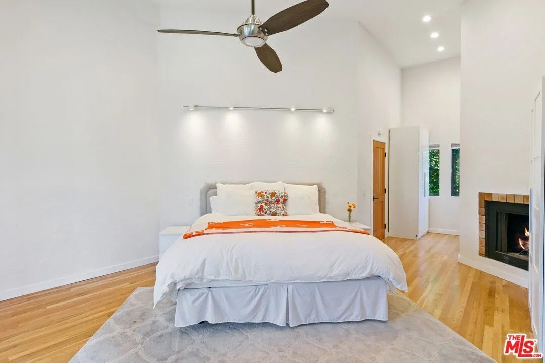 The primary suite occupies its own private wing, with a fireplace and luxurious double bath. 
