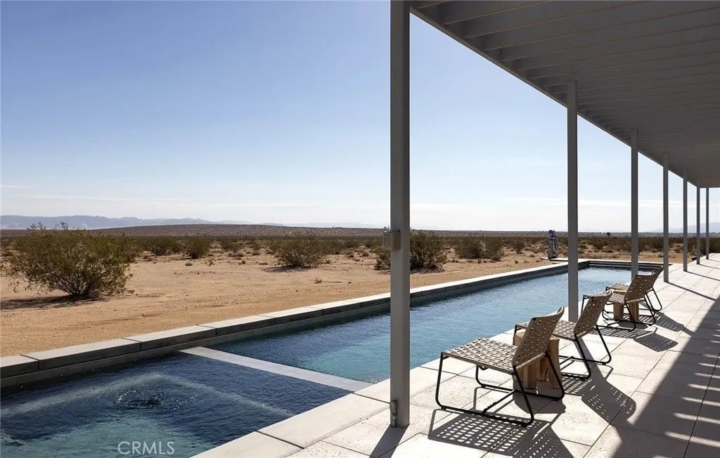 Outdoor amenities include a lap pool bodered by a covered deck with expansive desert views.