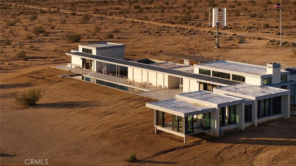 The four bedroom, three bath compound sits on a 160-acre lot, and has wind, thermal and solar power sources.
