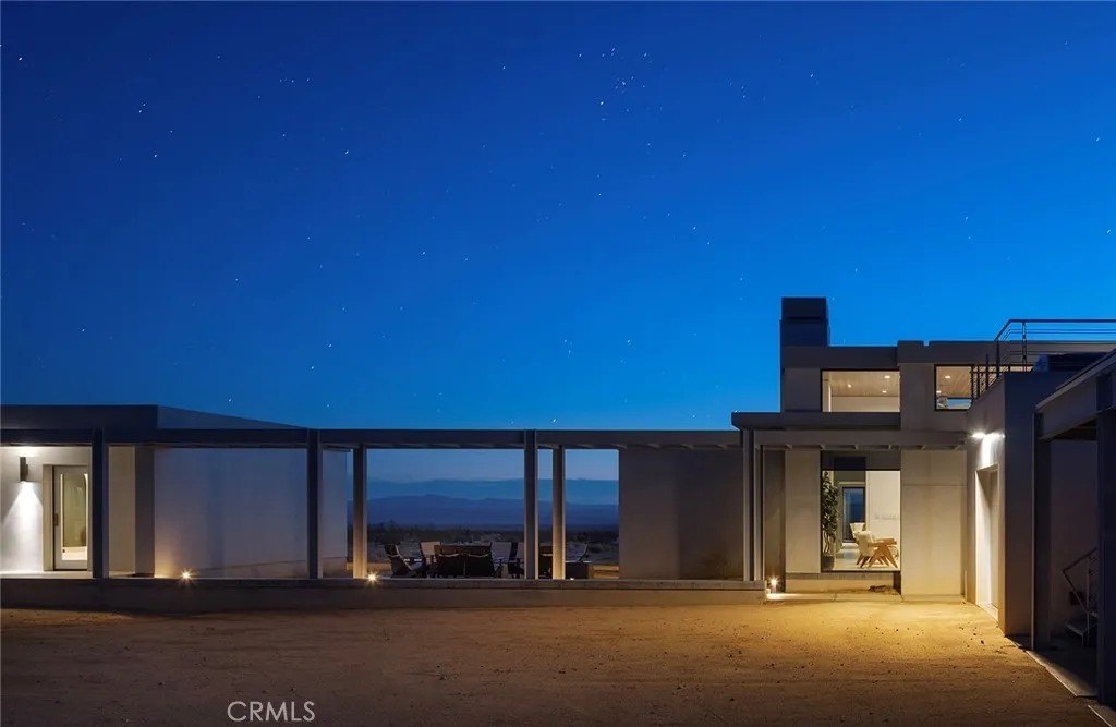 The concept features minimalistic, sculptural rooms connected by open-air corridors that maximize desert vistas.