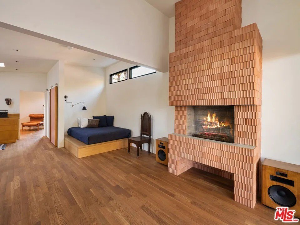 The guesthouse/studio contains it contains one bedroom, one full bath, and a great room with a beautiful, one of a kind period fluted terracotta tile fireplace.
