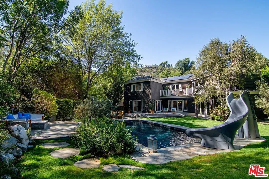 The leafy backyard includes a saltwater pool and spa.