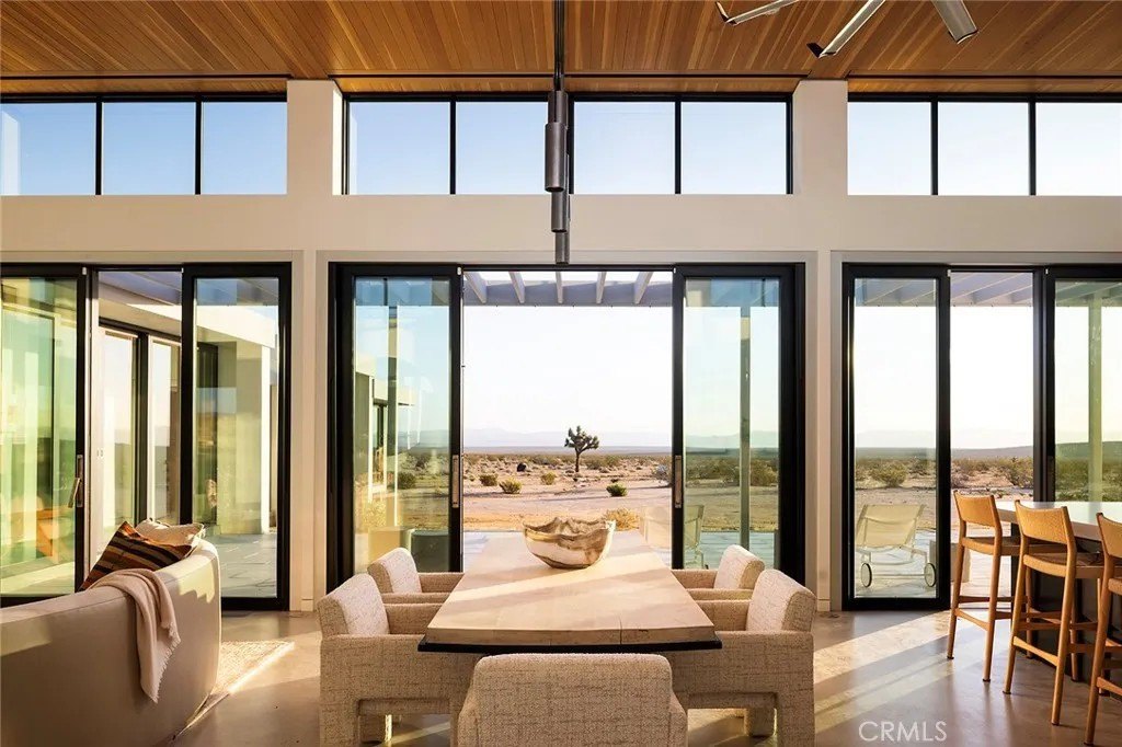 Mostly constructed of concrete, steel, and glass, the compound consists of four distinct structures, among them a 2,110 square foot main residence with a wide open great room, high ceilings, walls of glasss and radiant heated flooring.