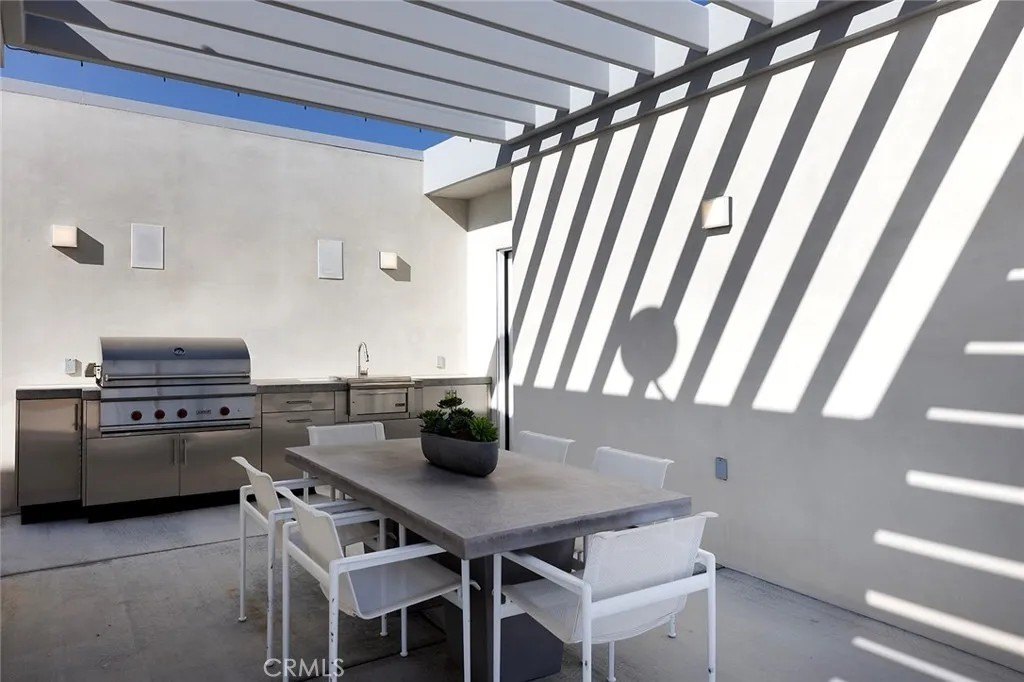 There's also an outdoor kitchen and dining area with an architecturally slatted roof.