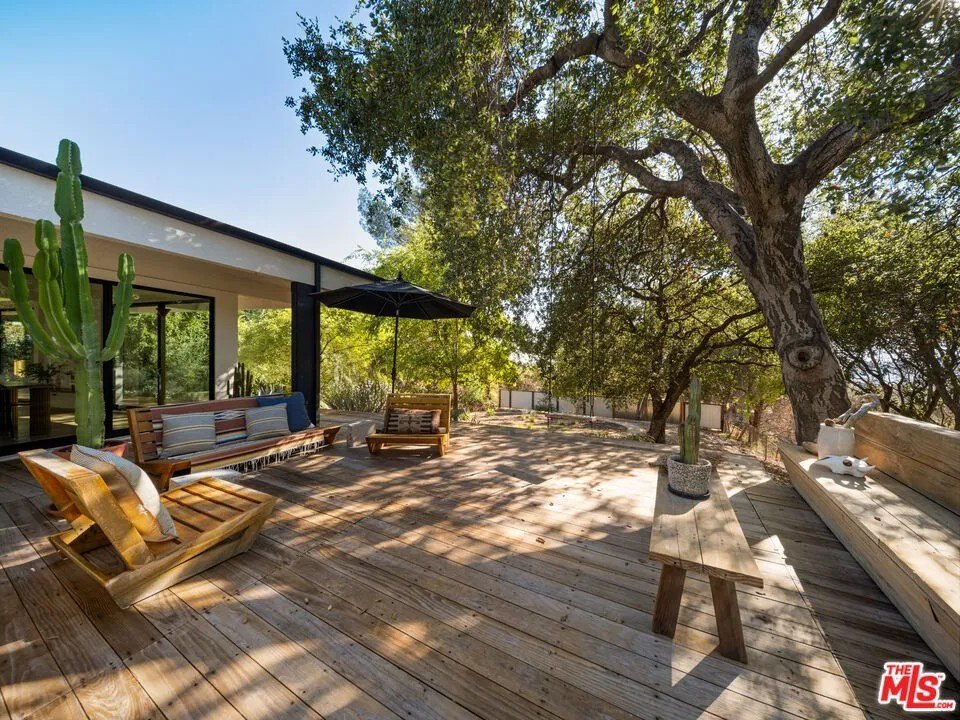 Multiple, shaded wooden decks provide ample space for outdoor entertaining.